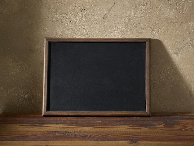 Schoolbord in een houten frame op een tafel in het interieur van de kamer