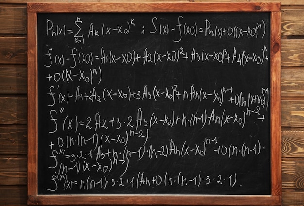 Foto schoolbord met formules op een bakstenen muur