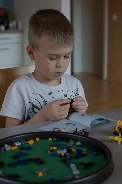 The schoolboy collects a figure from the details of the constructor