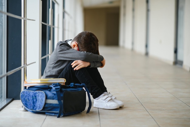 Schoolboy crying in the yard of the school negative emotion