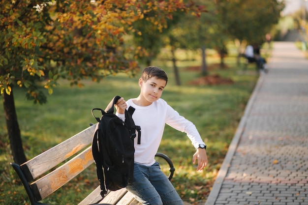 Schoolboy go to school in the morning Happy teenager in white shirt with black backpack go to study