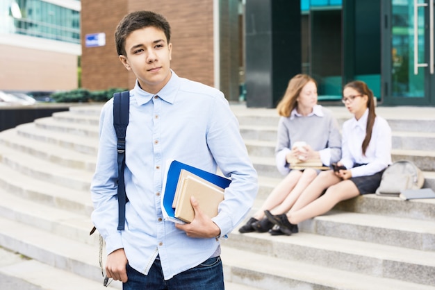 Schoolboy Heading home from school with textbooks in hand