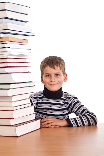 Schoolboy and a heap of books