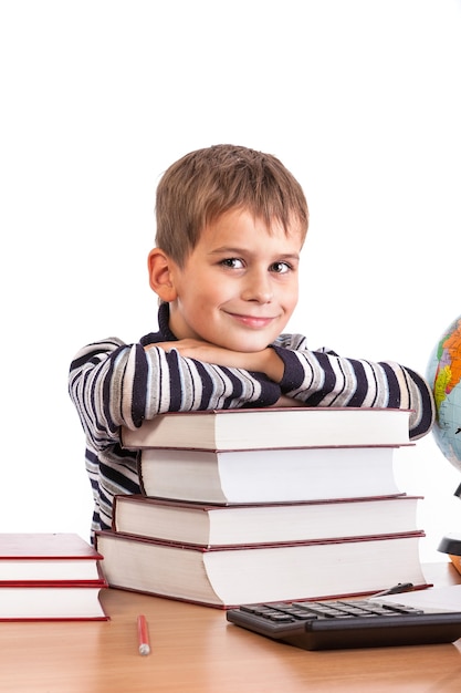 Schoolboy and a heap of books