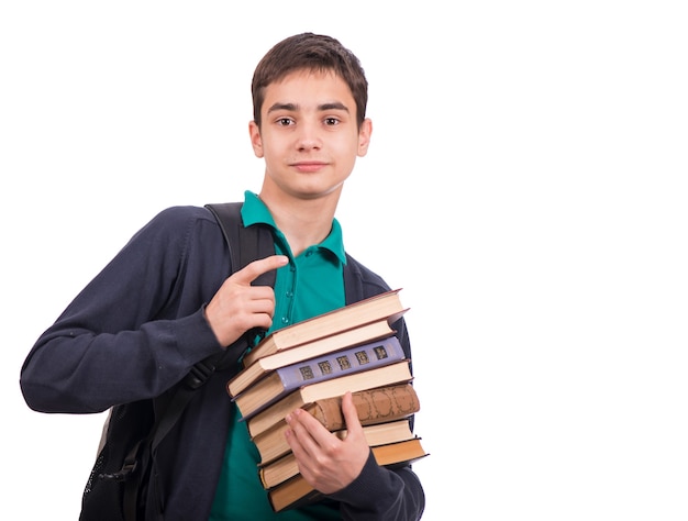 Schoolboy holding a stack of books, textbook isolated on white background . Close-up.