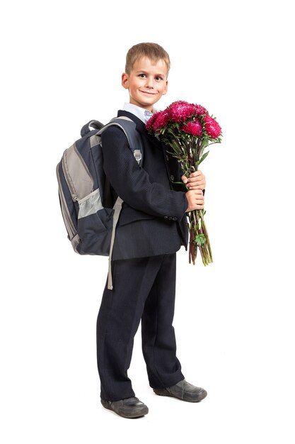 Schoolboy is holding bouquet of flowers