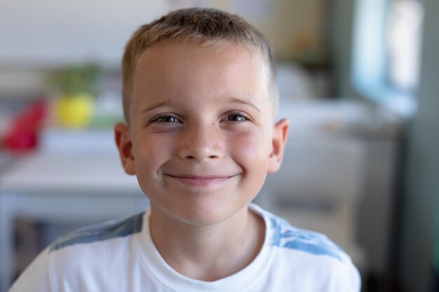 Schoolboy looking to camera  in an elementary school classroom in an elementary school classroom