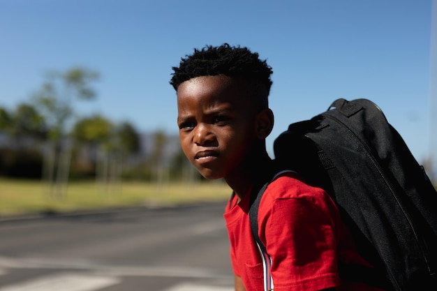 Schoolboy looking for traffic while waiting to cross the road