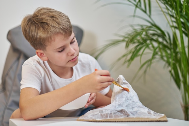 Schoolboy makes creative project in form of papier mache mountain