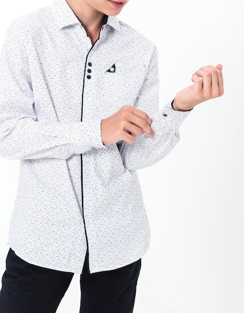 Schoolboy in a shirt on a white background Boy demonstrating shirt cuffs Vertical video