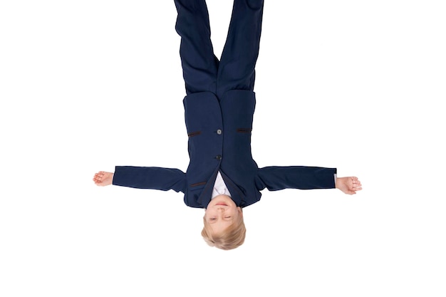 Schoolboy spread your arms to the side spread your arms to the side in isolation on white background Child in school uniform