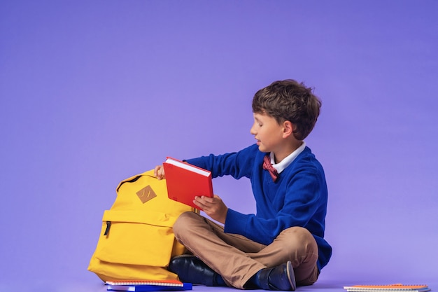 Schoolboy in uniform with a backpack