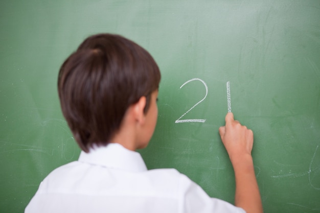 Schoolboy writing an addition