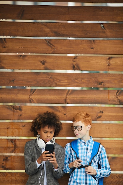 Photo schoolboys using mobile phone