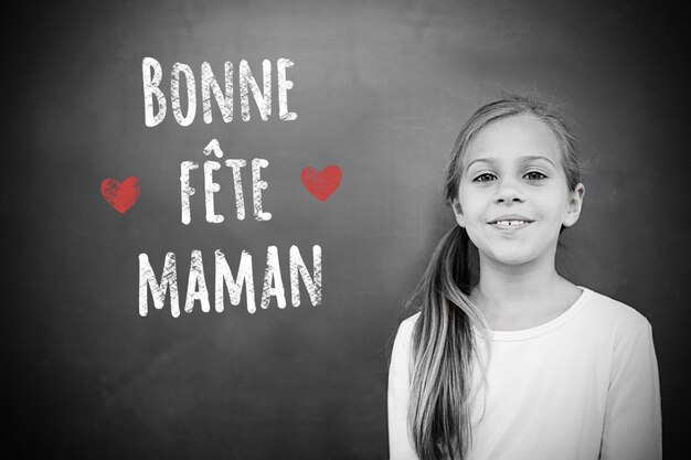 Schoolchild with blackboard against french mothers day message