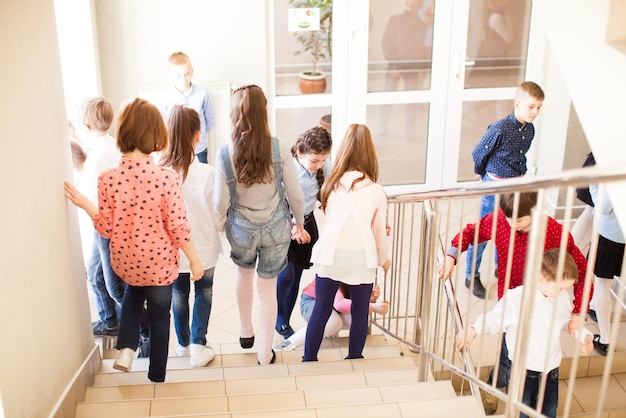 Schoolchildren in the school hallway talking resting during the break