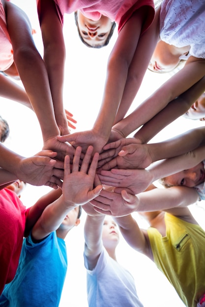 Schoolchildren stacking hands