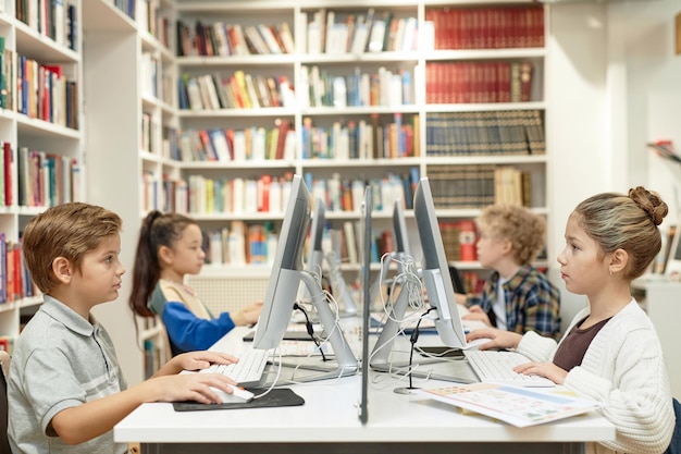 Schoolchildren using pc computers init programming class