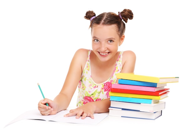 a schoolgirl doing homewor over white background