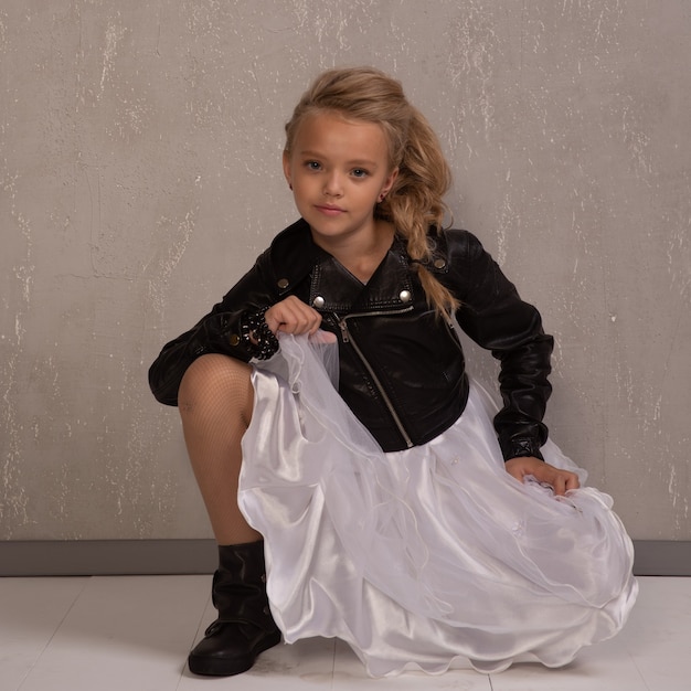 Schoolgirl girl in leather jacket and white skirt