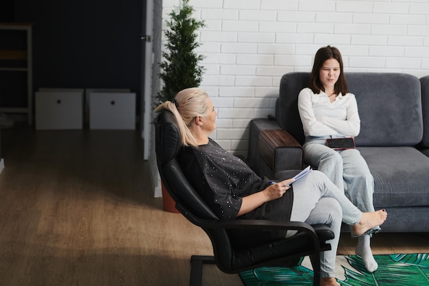schoolgirl girl at a psychological session with a child psychotherapist in a cozy office