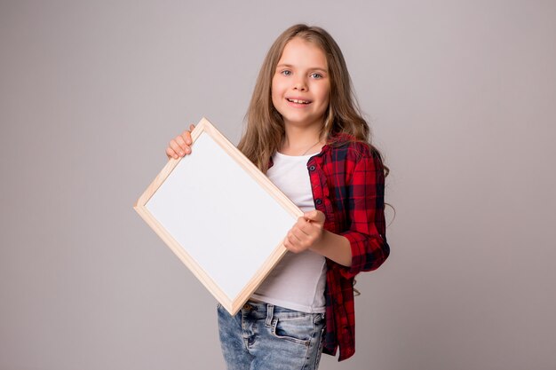 schoolgirl holding an empty white board