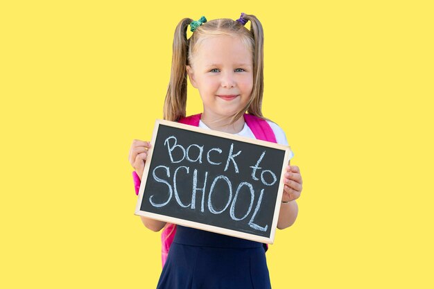 Photo schoolgirl holds a sign with the words 