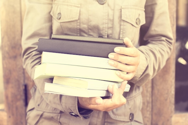 Schoolgirl is keeping a pack of books