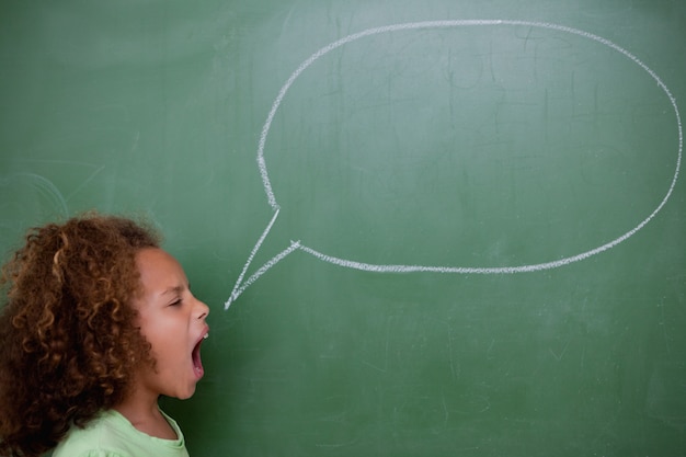 Photo schoolgirl screaming a speech bubble