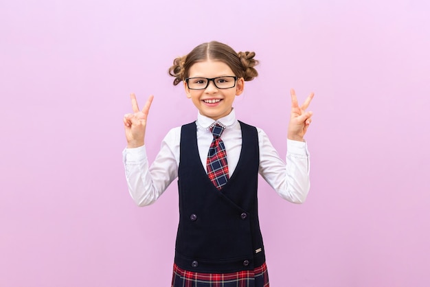 The schoolgirl shows her fingers on her hands A student on an isolated background