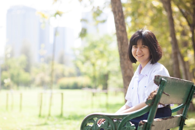 Schoolgirl sitting on the bench.