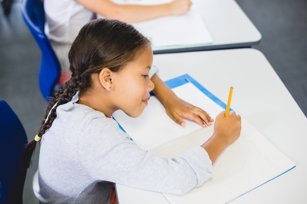 Schoolgirl studying in classroom