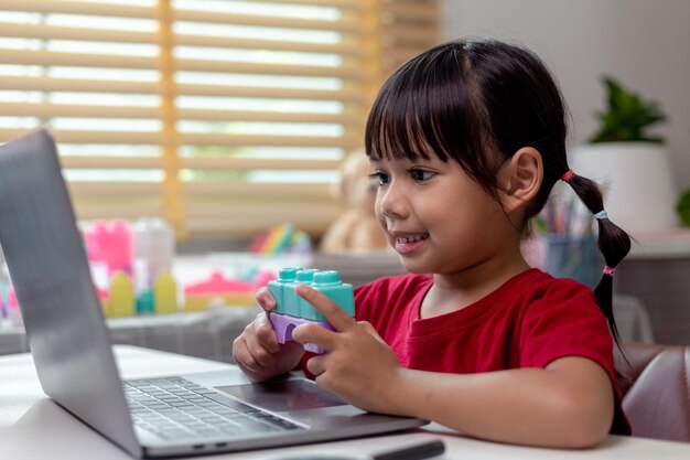 Schoolgirl studying homework math during her online lesson at home social distance during quarantine