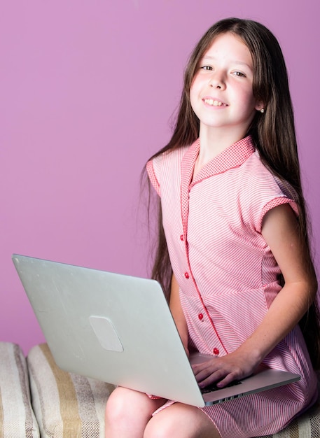 Schoolgirl surfing internet Do homework or play games Watching video Distant education Pupil study digital technology Modern life Modern technology Education nowadays demand modern gadgets