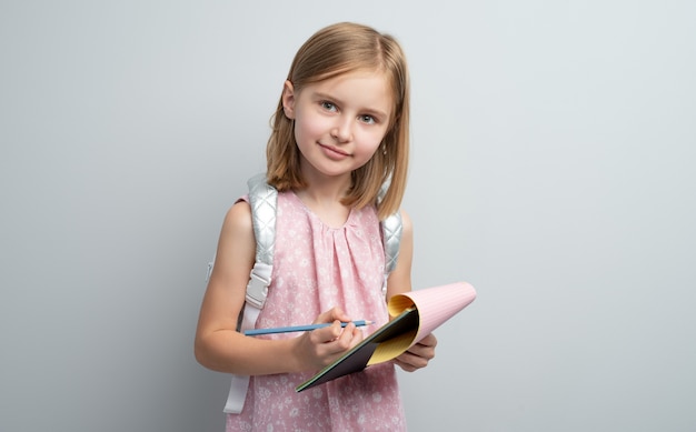 Schoolgirl taking notes in writing pad