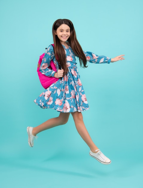 Schoolgirl with backpack Teenager student isolated background Learning and knowledge Go study Run