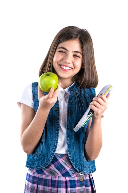 Schoolgirl with notebook and apple on white