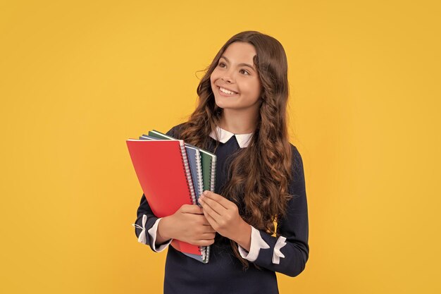 Schoolgirl with notebook back to school teen girl ready to study happy childhood