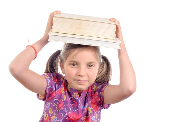 Schoolgirl with pile of books on head