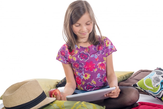 Schoolgirl with a tablet and apple