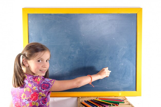 schoolgirl writing on a blackboard