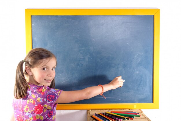 Schoolgirl writing on a blackboard