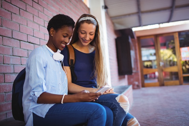 Schoolgirls using mobile phone