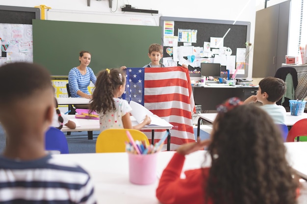 Foto schooljongen met een amerikaanse vlag in de klas