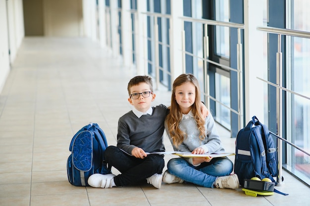 Schoolkinderen in uniform samen in gang conceptie van onderwijs