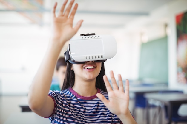 Schoolmeisje die virtuele werkelijkheidshoofdtelefoon in klaslokaal gebruiken
