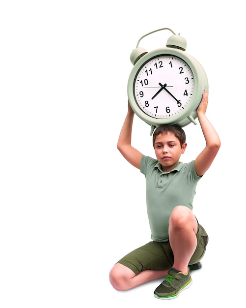 Schools start too early. Little boy with large alarm clock.