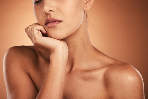 Schoonheid huidverzorging en close-up van een vrouw in een studio met een natuurlijke huidroutine voor wellness Cosmetica gezicht en gezicht van een model met een gezichtsbehandeling geïsoleerd door een bruine achtergrond met kleurovergang