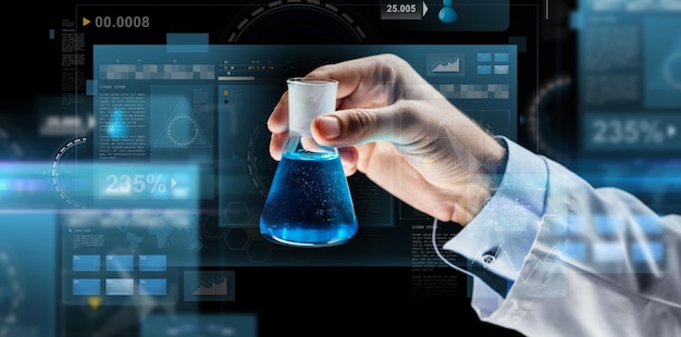 science, chemistry, research and people concept - close up of scientist hand holding test flask with chemical and virtual screens over dark background