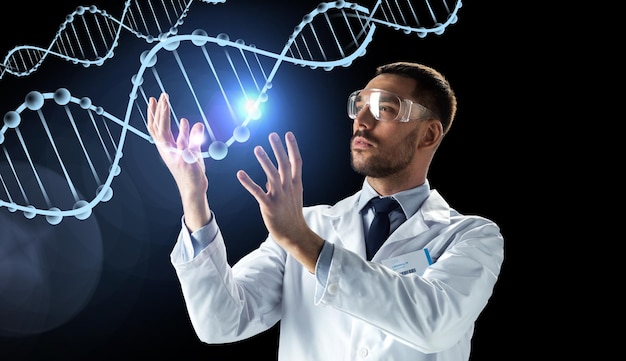 science, genetics and people concept - male doctor or scientist in white coat and safety glasses with dna molecule projection over black background